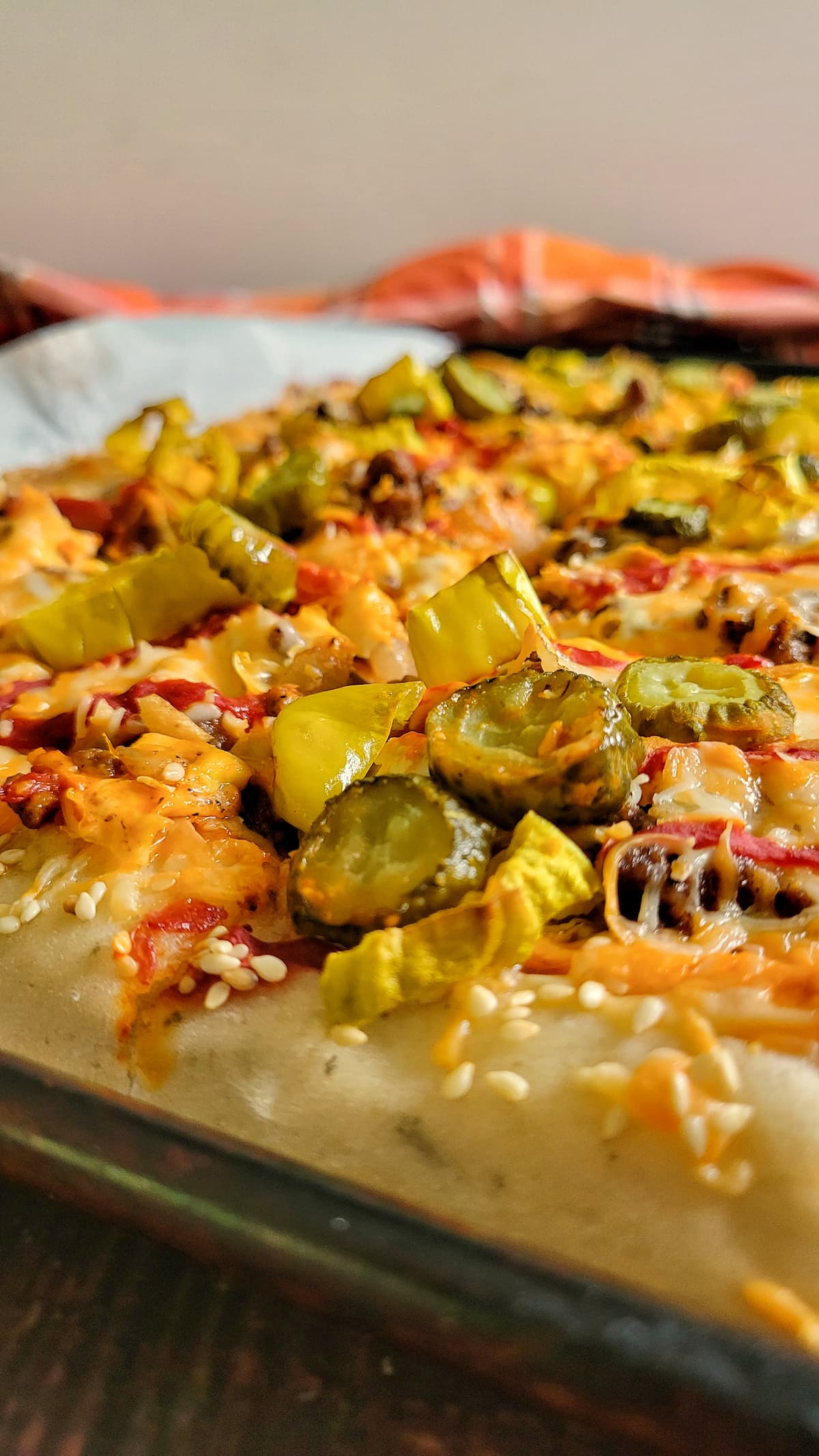 pizza with pickles, sesame seeds, pepperoncini