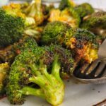 charred broccoli with garlic and spices on a plate