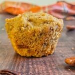 carrot cake muffin surrounded by pecans