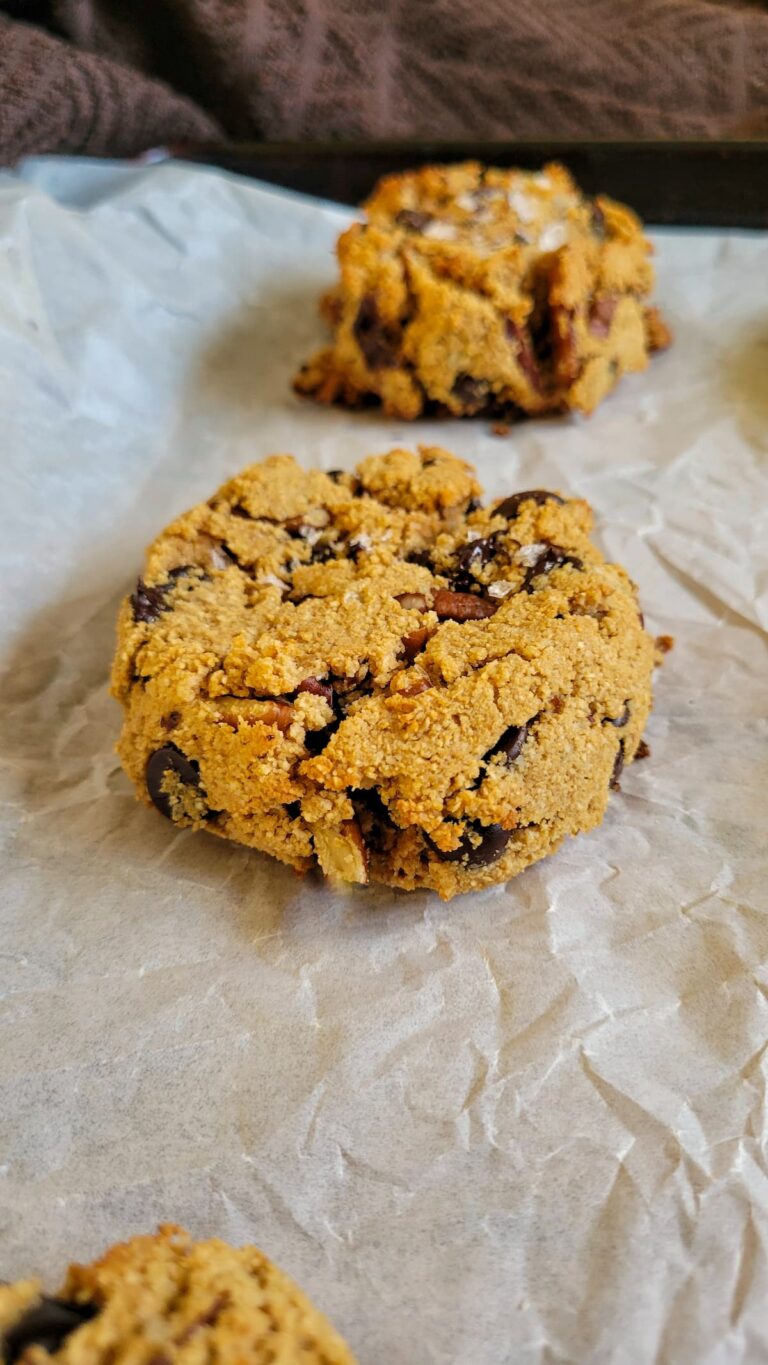 pecan chocolate chip cookies on a piece of parchment