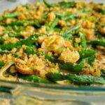 green bean bake topped with crushed pork rinds in a casserole dish
