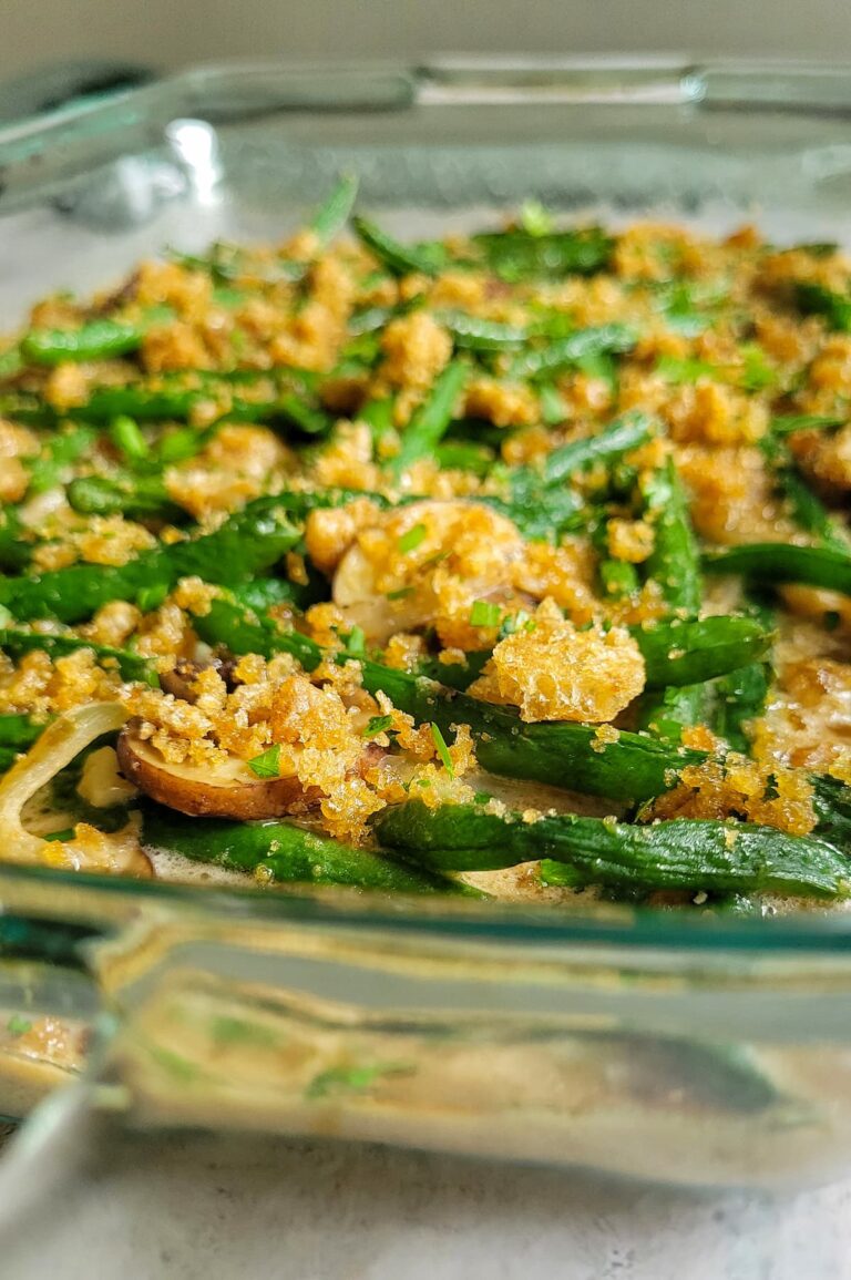 green bean bake topped with crushed pork rinds in a casserole dish