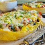 spaghetti squash boat stuffed with ground turkey and veggies, topped with mozzarella cheese and fresh chopped parsley