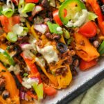 loaded bell pepper nachos with jalapenos, green onions, tomatoes, ground beef, cheese, lime crema