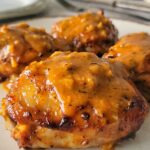 saucy chicken thighs on a plate