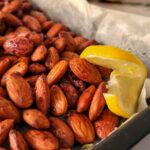 tray of roasted almonds with lemon