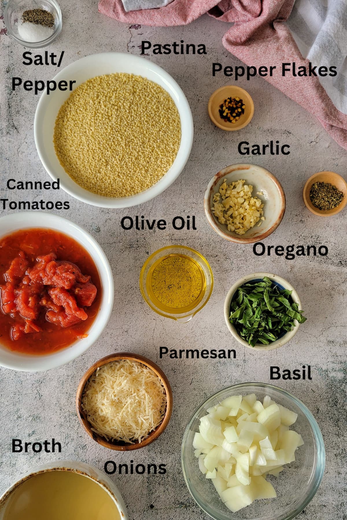 ingredients for tomato pastina - salt, pepper, pastina, pepper flakes, garlic, oregano, olive oil, canned tomatoes, basil, parmesan, onions, broth