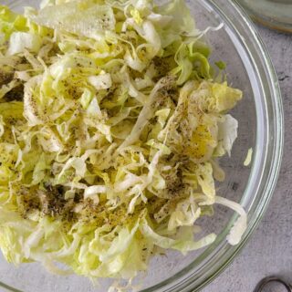 bowl of iceberg lettuce salad with spices