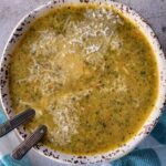 bowl of broccolini soup with two spoons