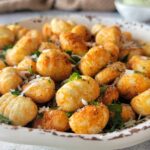 bowl of air fried gnocchi with parmesan and parsley