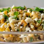 bowl of elote pasta salad with cotija cheese, corn, cilantro, green onions
