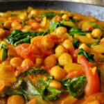 skillet with chickpeas, spinach, diced tomatoes, onions