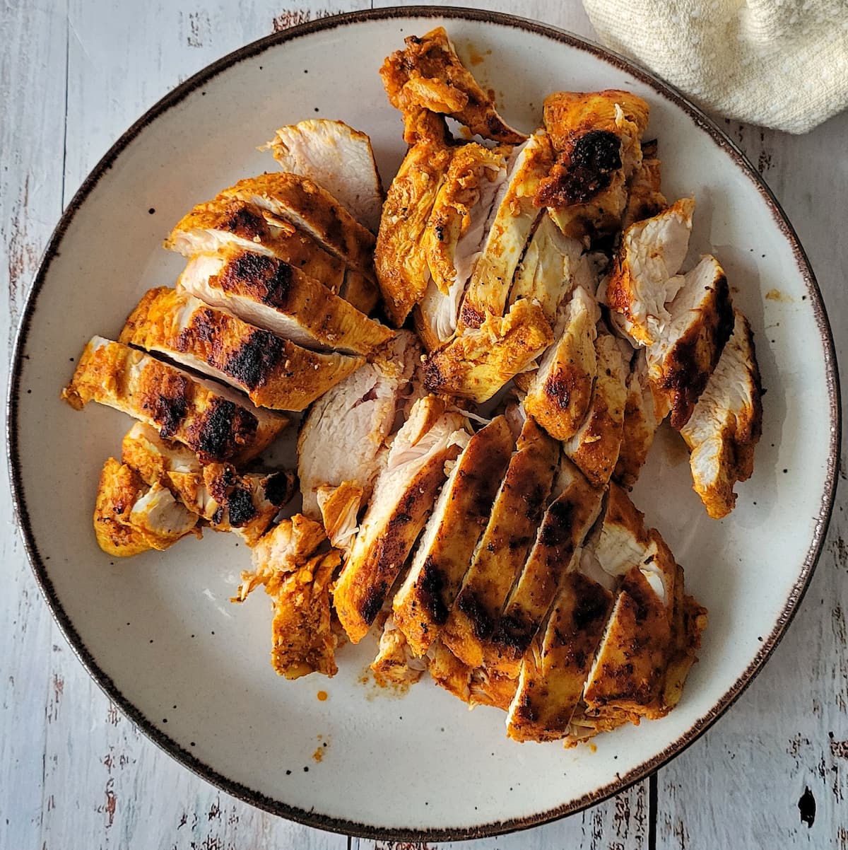 plate of cooked sliced seasoned chicken breasts