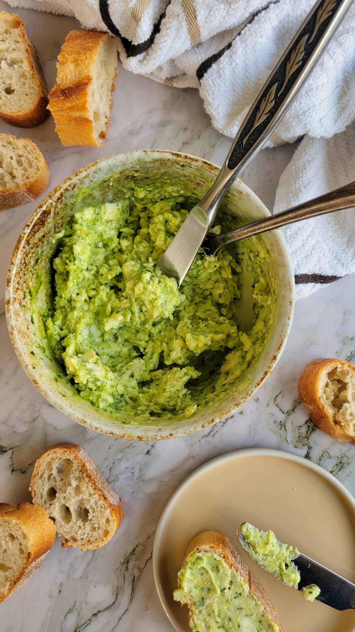 bowl of pesto butter, bread in the background