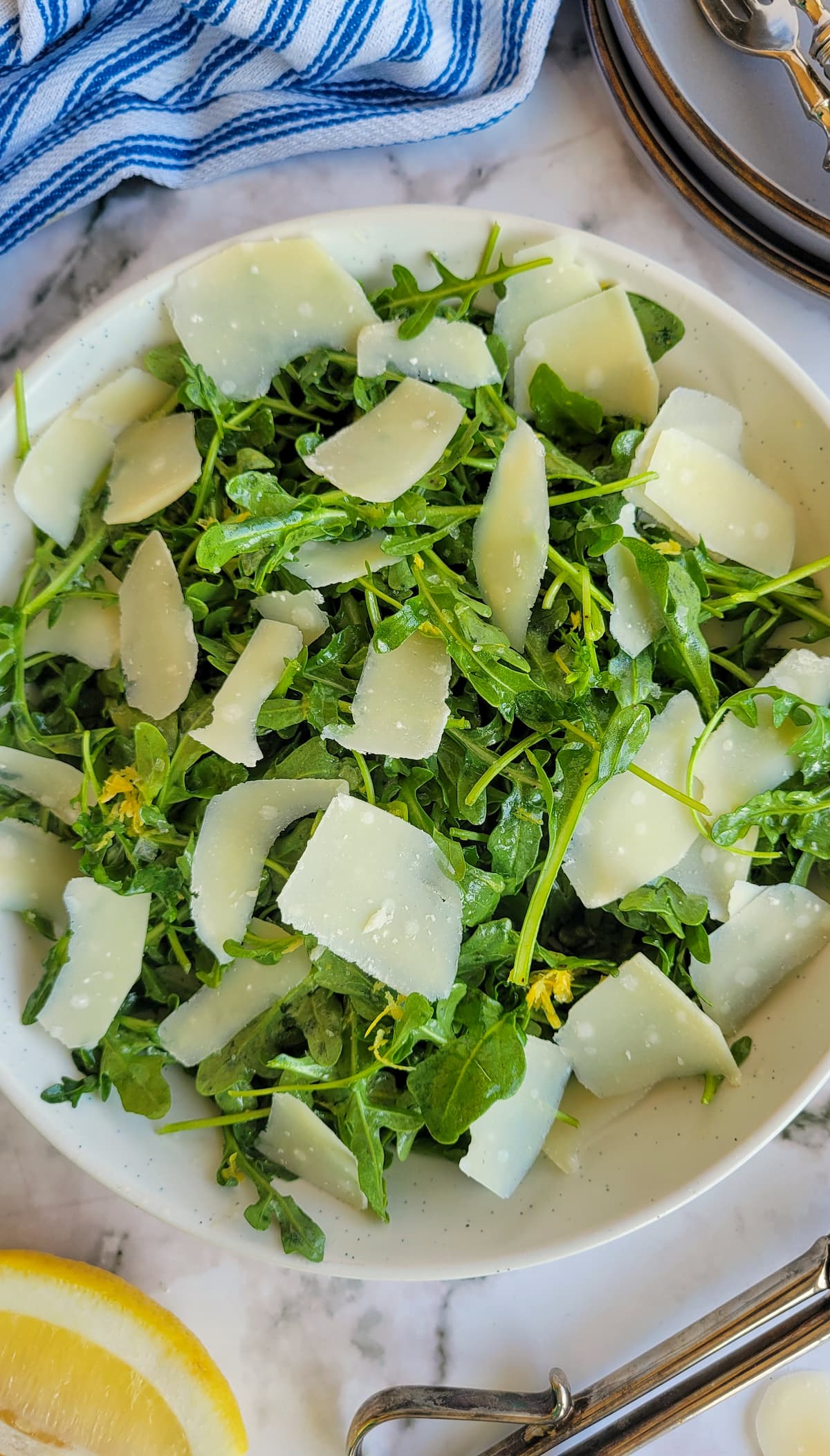 arugula salad with lemon and parmesan in a bowl