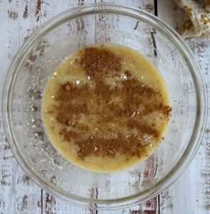 bowl of batter with cinnamon on top