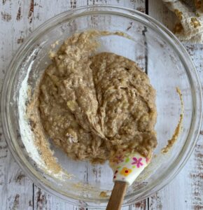 bowl of banana bread batter with a rubber spatula