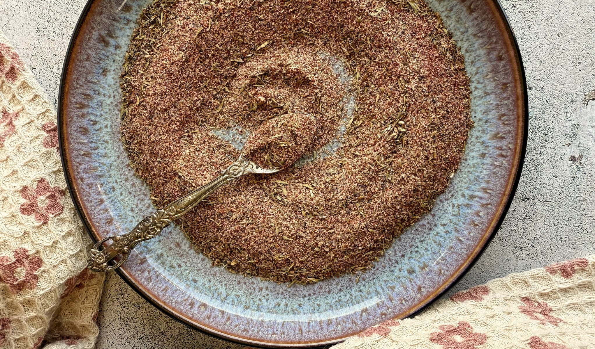 cajun seasoning on a plate with a spoon