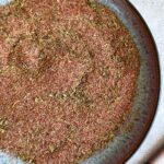 mixed seasonings on a plate next to a spoon