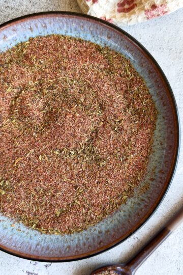 mixed seasonings on a plate next to a spoon