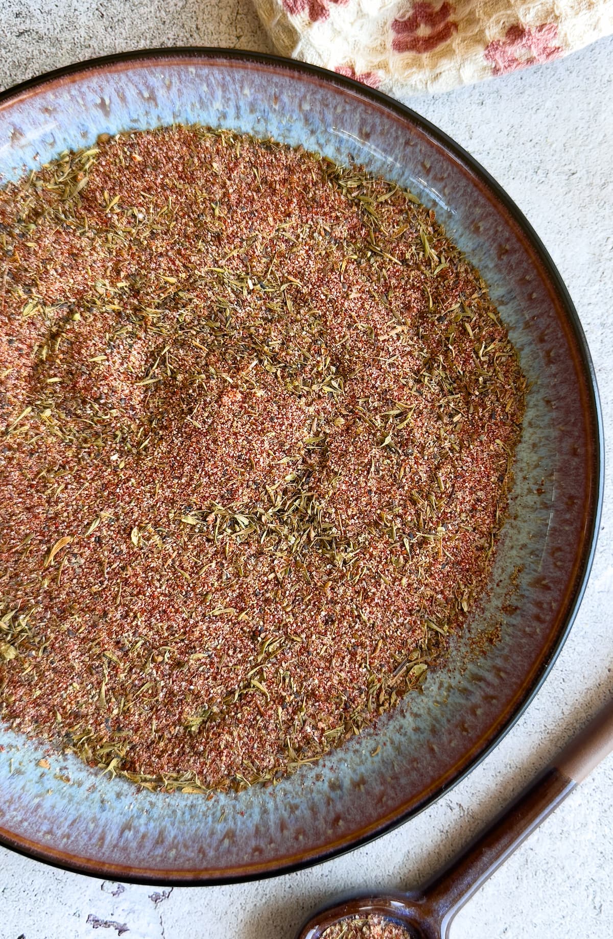 mixed seasonings on a plate next to a spoon