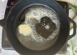 butter melting in a cast iron skillet