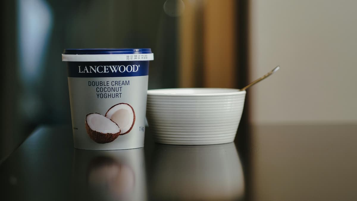 coconut yogurt next to a bowl with a spoon in it
