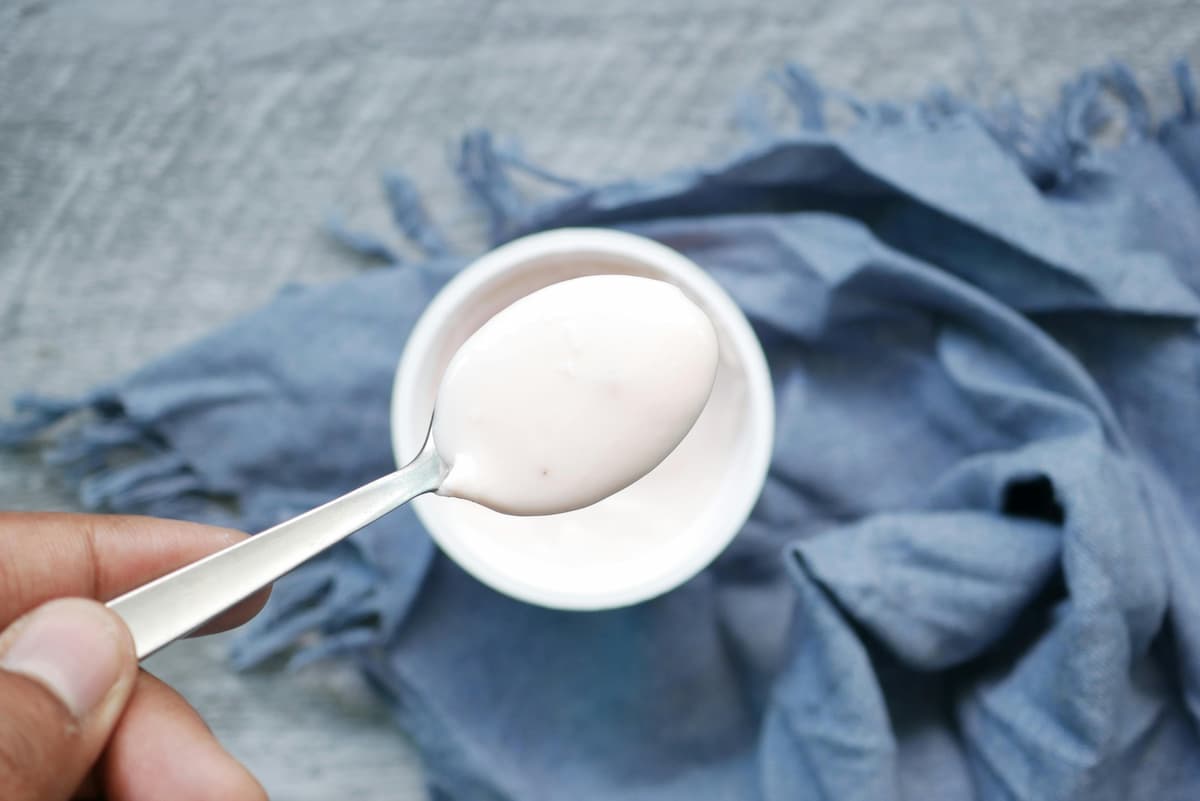 spoonful of plain yogurt over a cup with more