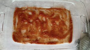 layer of tomato sauce at the bottom of a 9x13 baking dish