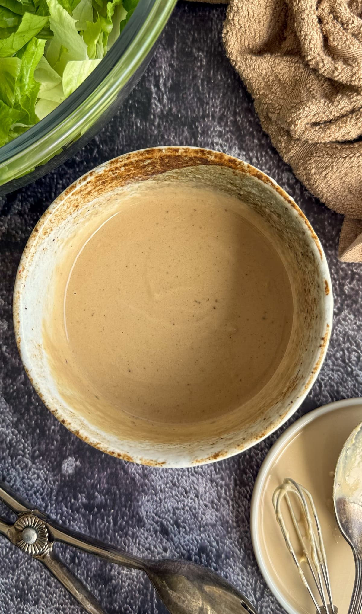 bowl of beige creamy sauce next to a bowl of chopped lettuce