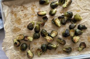roasted brussels sprouts on a parchment lined baking sheet