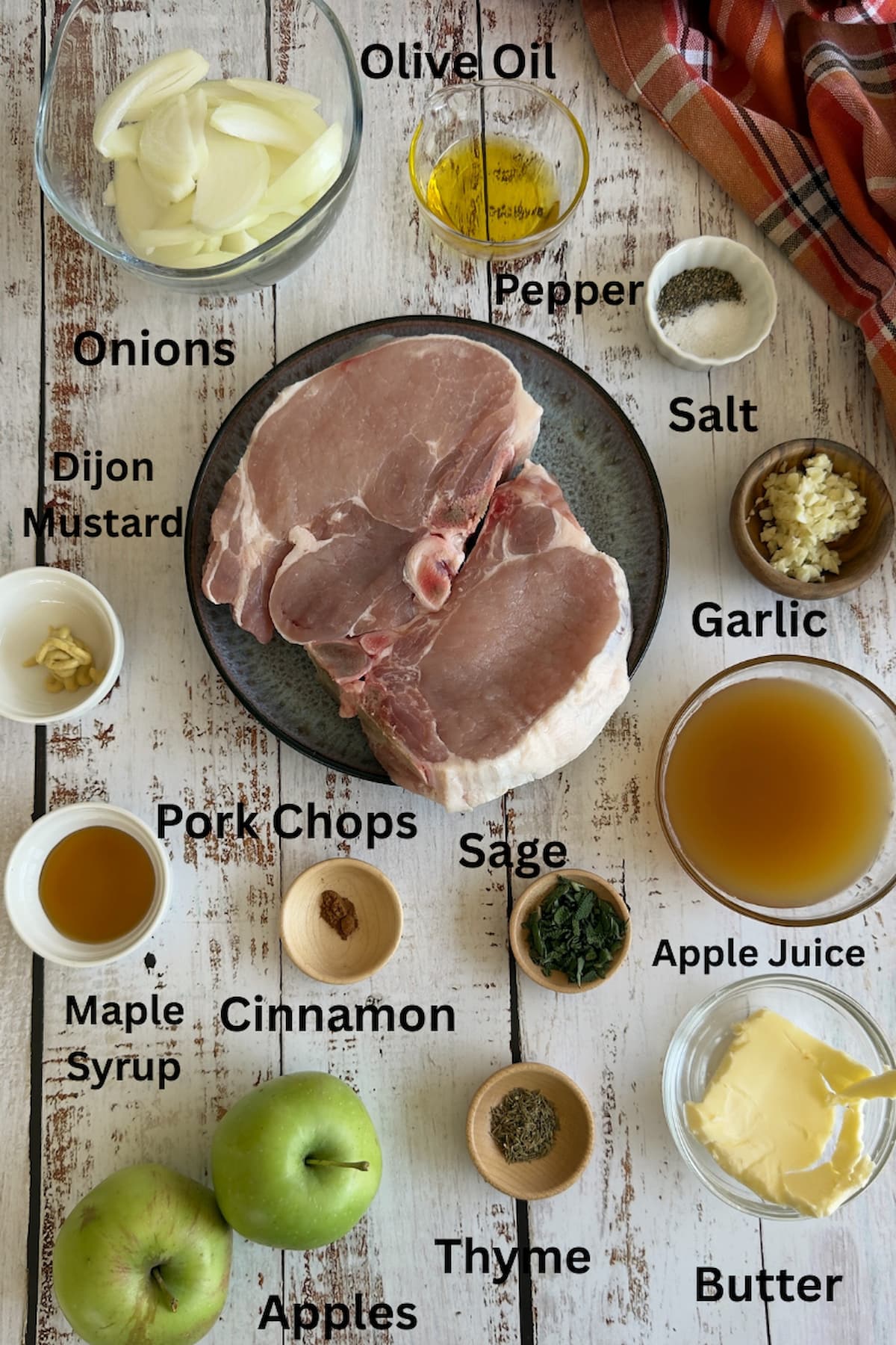 ingredients for pan seared pork chops - pork chops, olive oil, salt, pepper, onions, garlic, apples, sage, thyme, maple syrup, dijon mustard, apple juice, cinnamon, butter