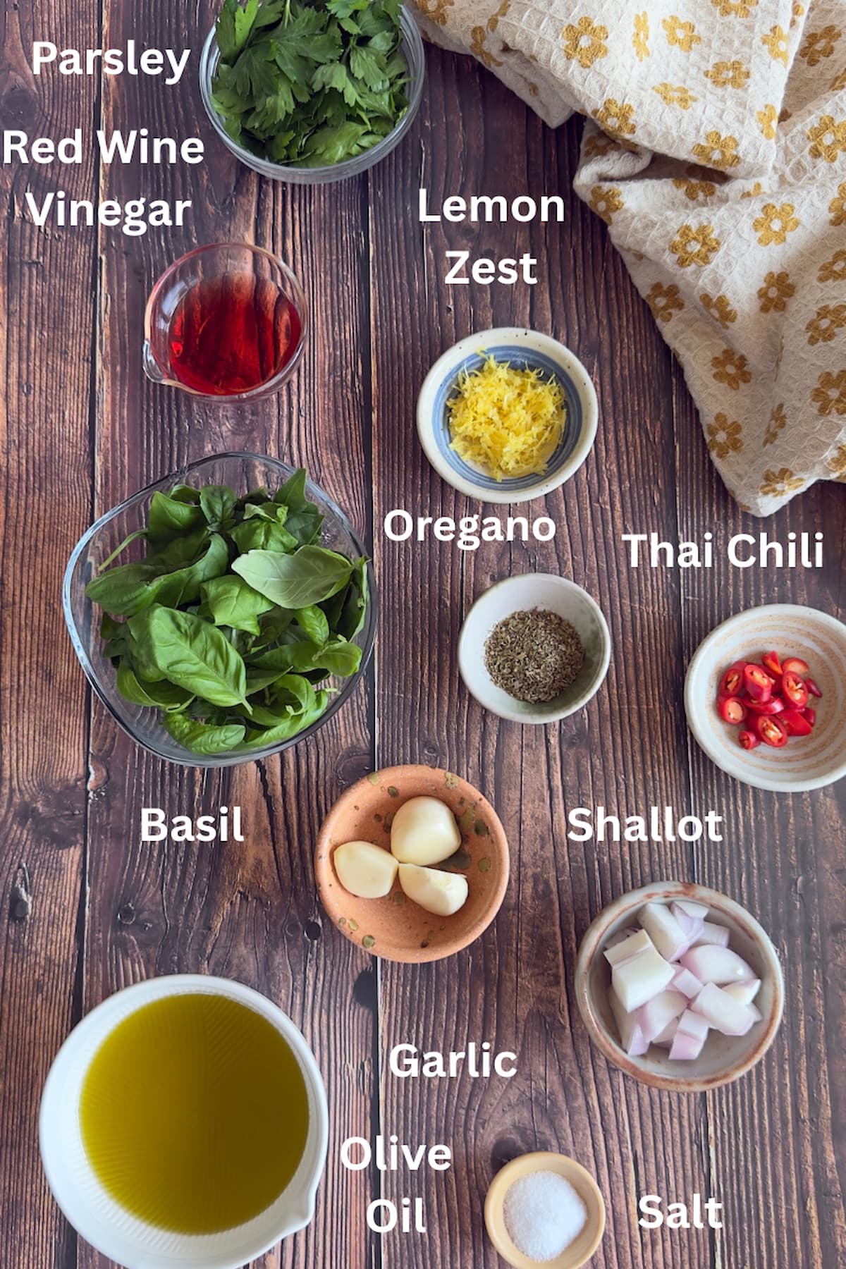 ingredients for basil chimichurri - parsley, basil, red wine vinegar, lemon zest, oregano, thai chili, shallot, salt, garlic, olive oil