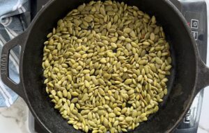 pumpkin seeds in a cast iron skillet