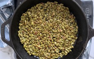 toasted pepitas in a cast iron skillet