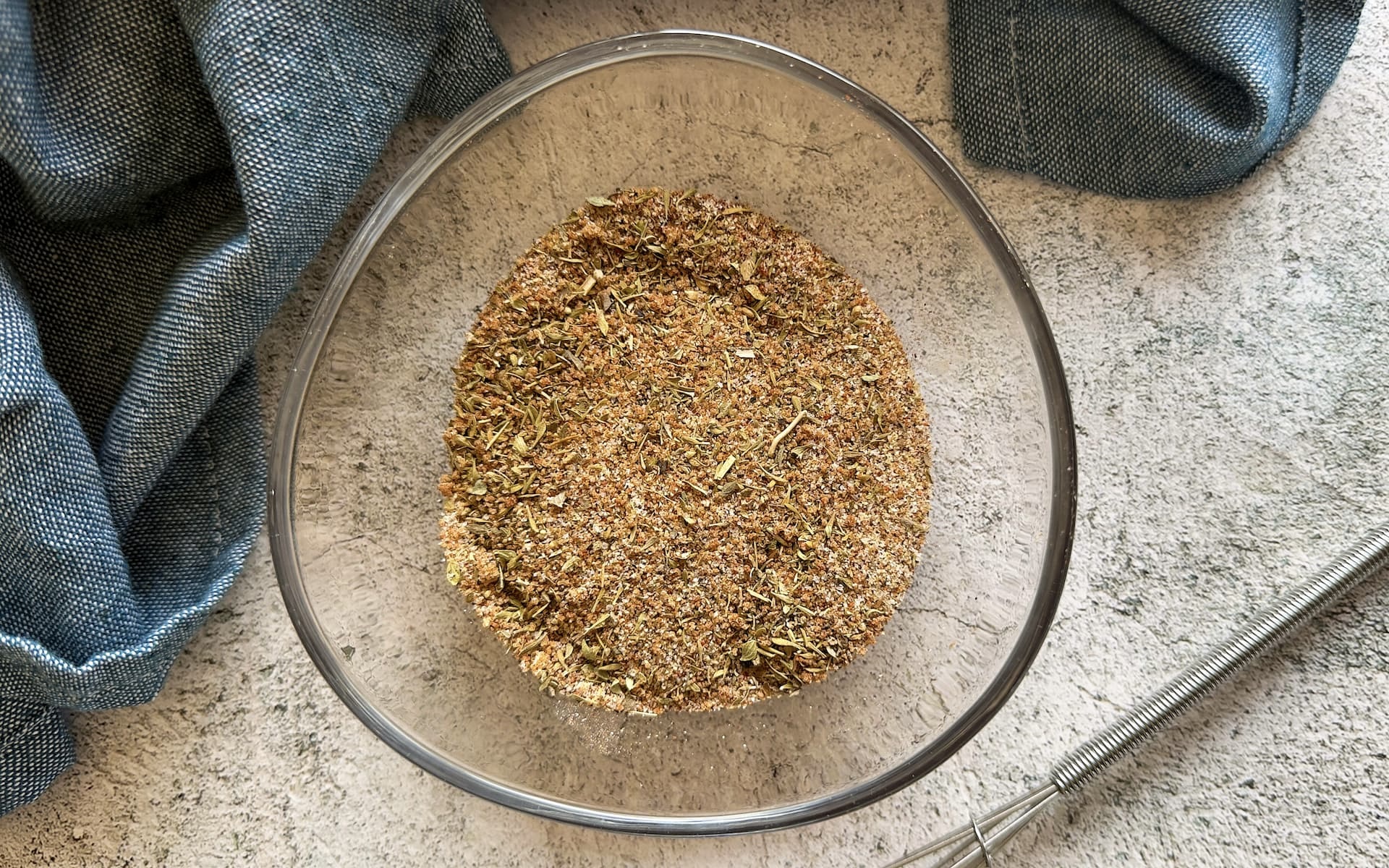 meatloaf seasoning in a bowl next to a small whisk