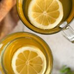 two glasses of rosehip tea with lemon slices