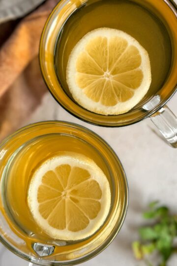 two glasses of rosehip tea with lemon slices