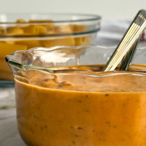 pumpkin sauce in a bowl in front of a bowl of pasta