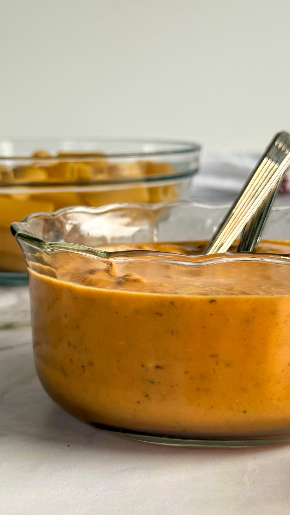 pumpkin sauce in a bowl in front of a bowl of pasta