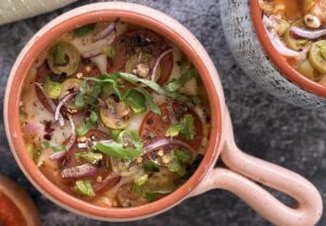 cottage cheese bowl with mozzarella, pepperoni, olives, chili flakes, green pepper, fresh basil