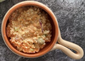 cottage cheese mixed with tomato sauce and pizza toppings in the bottom of a bowl