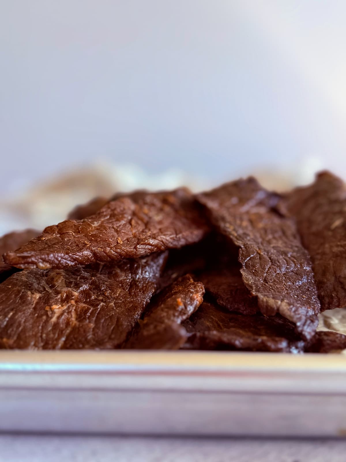 pile of beef jerky on a sheet pan.