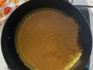 orange pumpkin curry sauce in a cast iron pot.