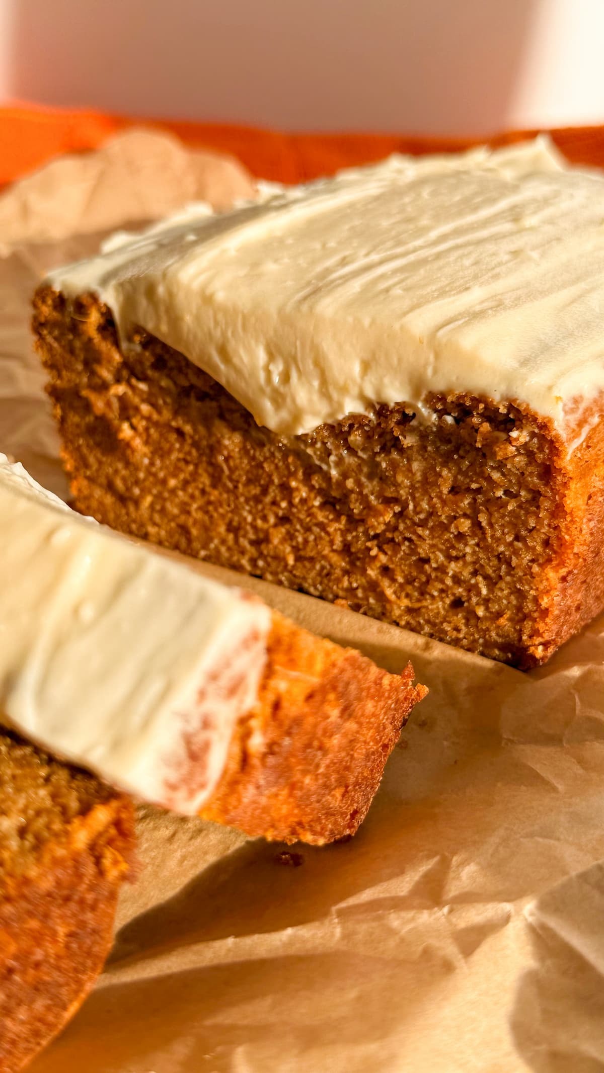 sliced pumpkin bread with cream cheese frosting.