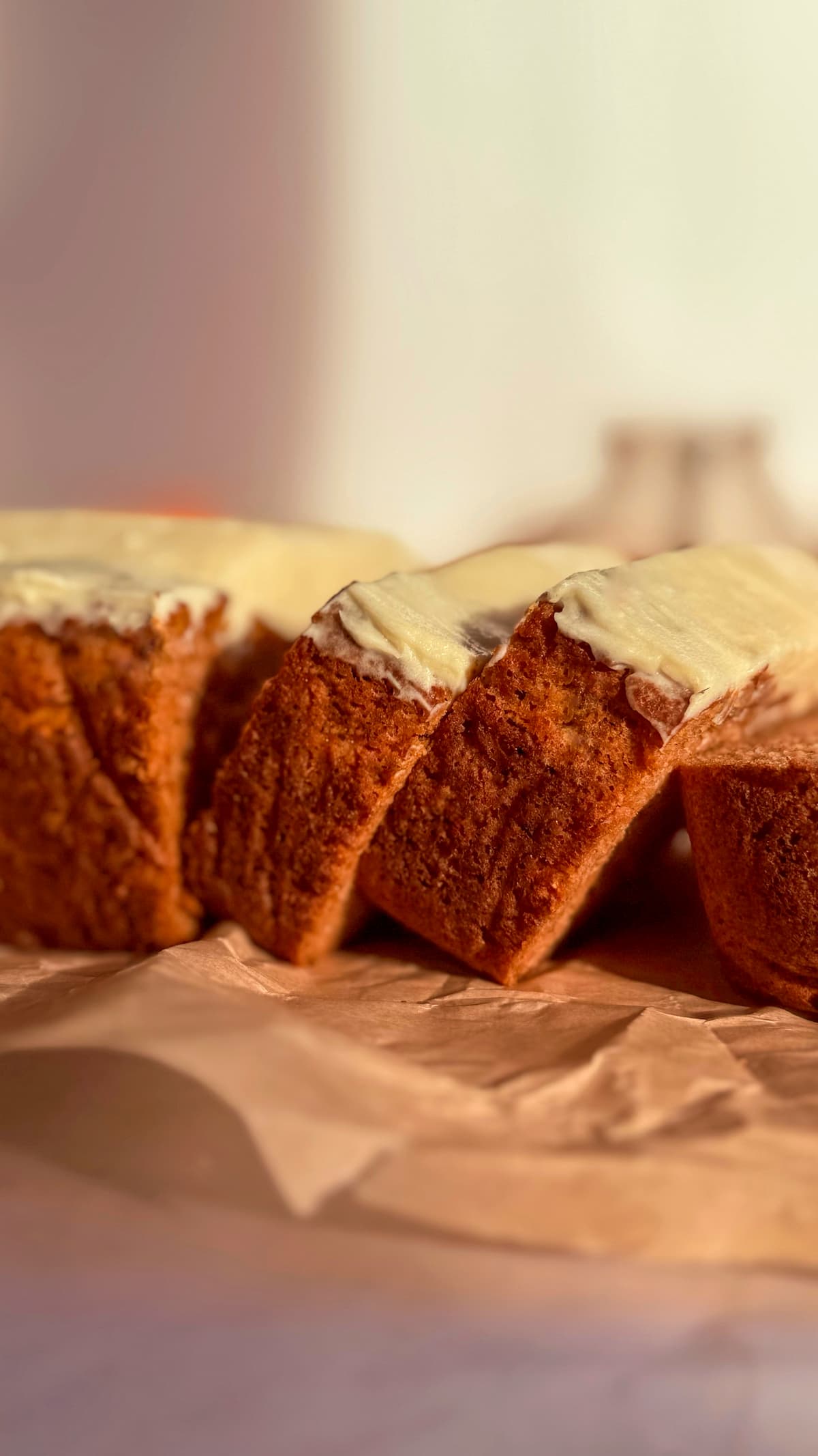 side view of sliced pumpkin bread with cream cheese frosting.
