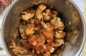 cauliflower florets, spices, and pumpkin puree in a soup pot.