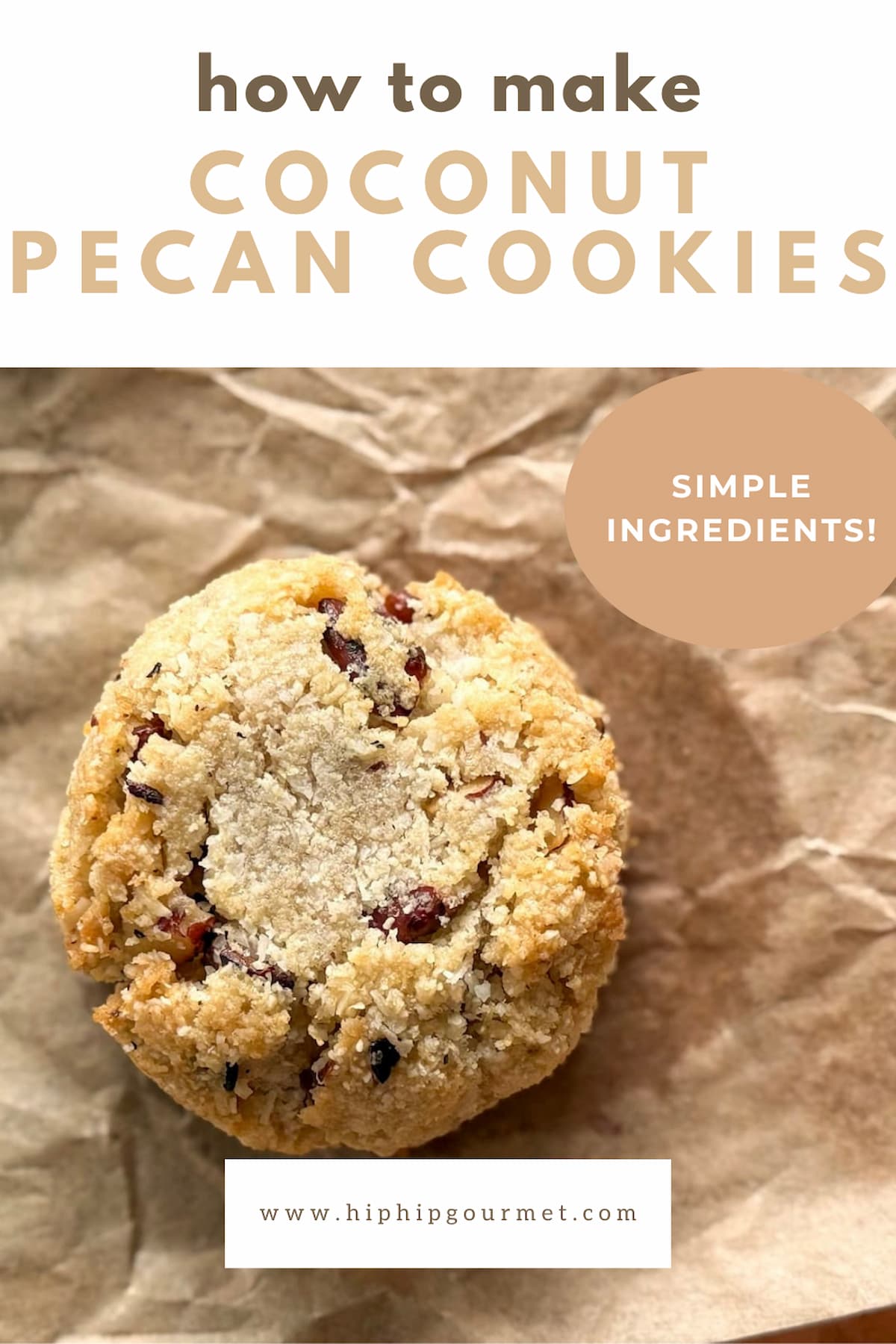 close up of a coconut cookie with pecans on a piece of parchment paper.
