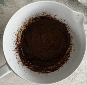 dark brown batter in a white bowl.