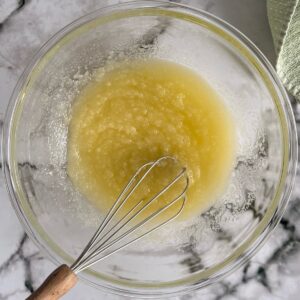 whisk in a bowl of mixed melted butter, sugar, and oil.